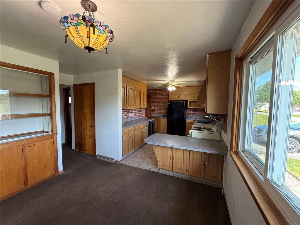 105 Ridgeview Drive Salix, PA 15952 - Photo 8 of 25 a view of a kitchen with a sink cabinet and a refrigerator