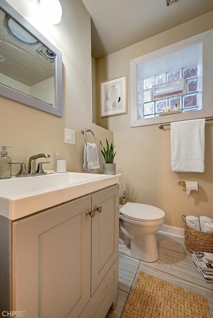 1716 South Clinton Street Chicago, IL 60616 - Photo 12 of 18 a bathroom with a sink toilet and mirror