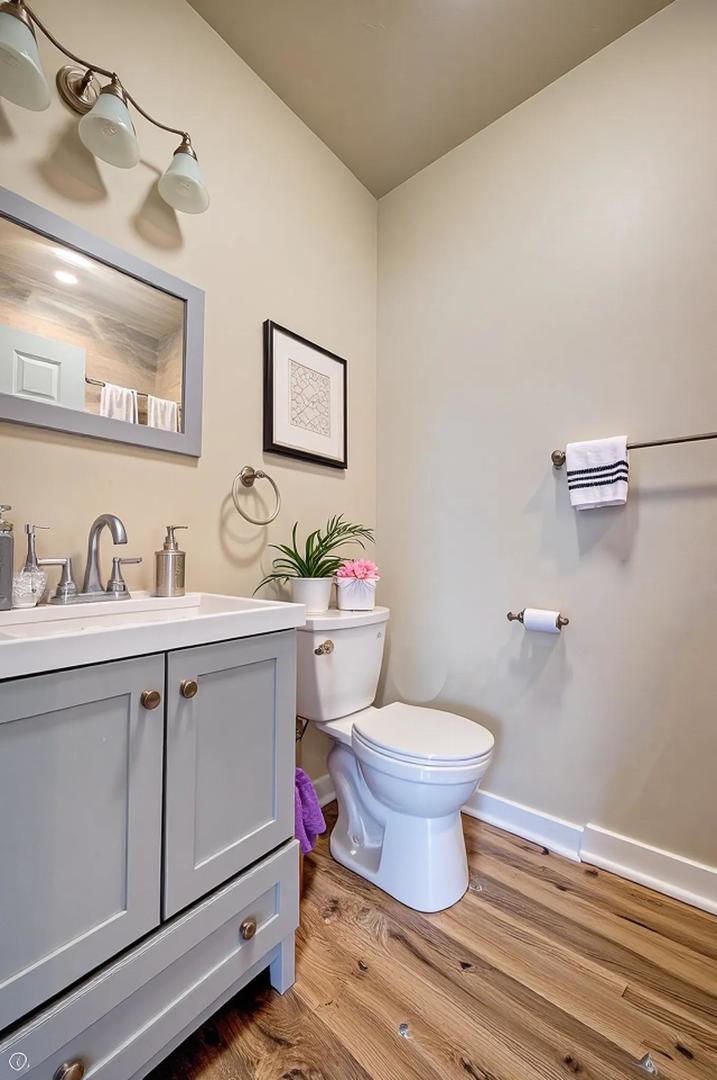 1716 South Clinton Street Chicago, IL 60616 - Photo 5 of 18 a bathroom with a granite countertop toilet sink and mirror
