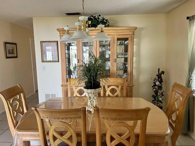 a view of a dining room with furniture and chandelier