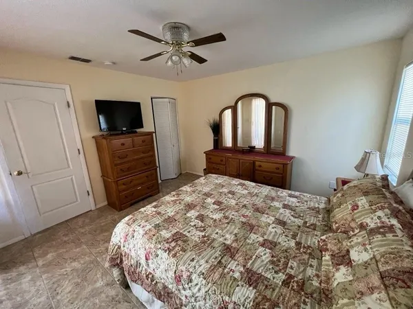 a bedroom with a bed and a television