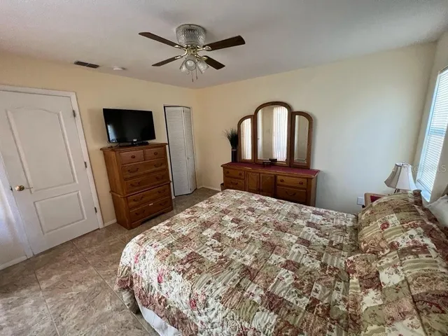 a bedroom with a bed and a television