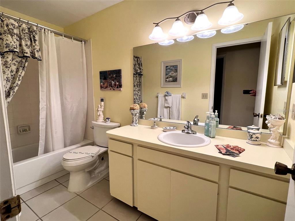 Undisclosed Address Bradenton, FL 34209 - Photo 22 of 38 a bathroom with a sink a toilet and a mirror