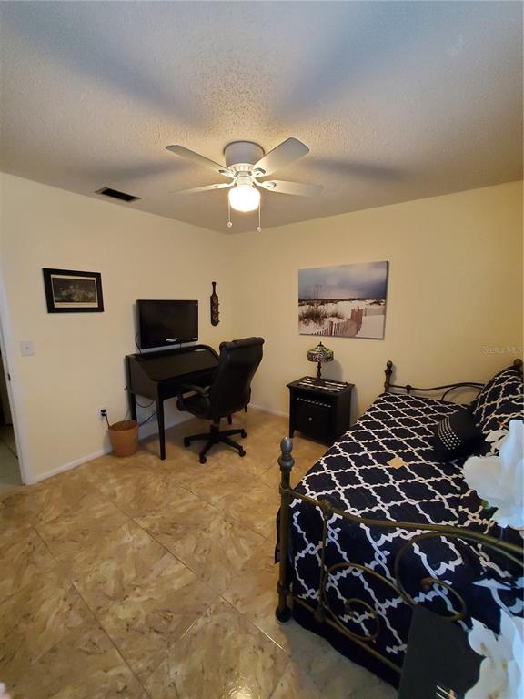 Undisclosed Address Bradenton, FL 34209 - Photo 25 of 38 a bedroom with a bed and a piano