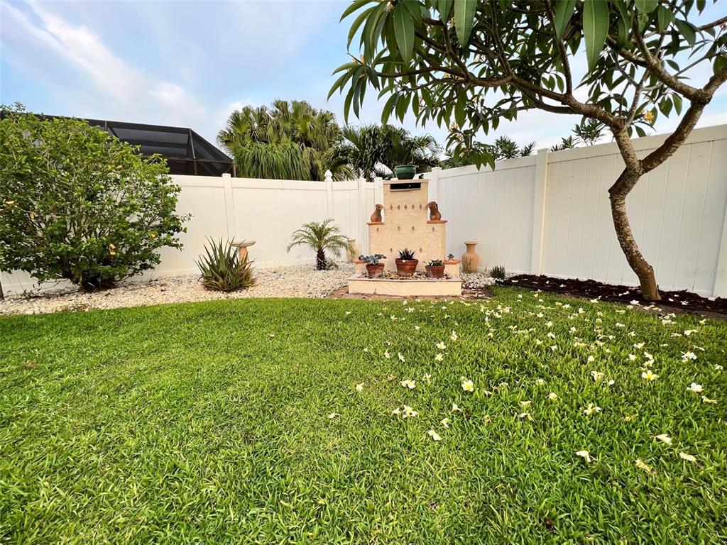 Undisclosed Address Bradenton, FL 34209 - Photo 35 of 38 a backyard of a house with table and chairs under an umbrella