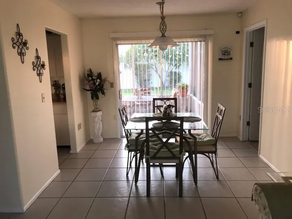 a view of a dining room with furniture and chandelier