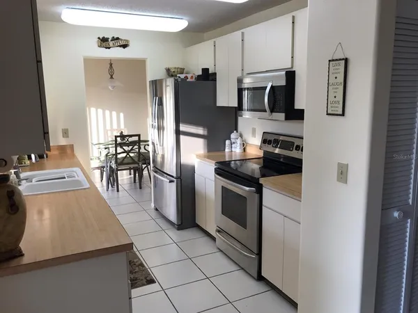 a kitchen with stainless steel appliances a stove a microwave and a refrigerator
