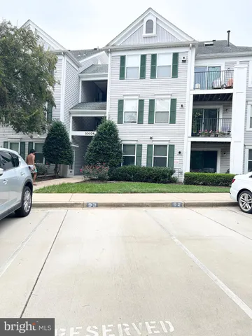 a view of building with car parked