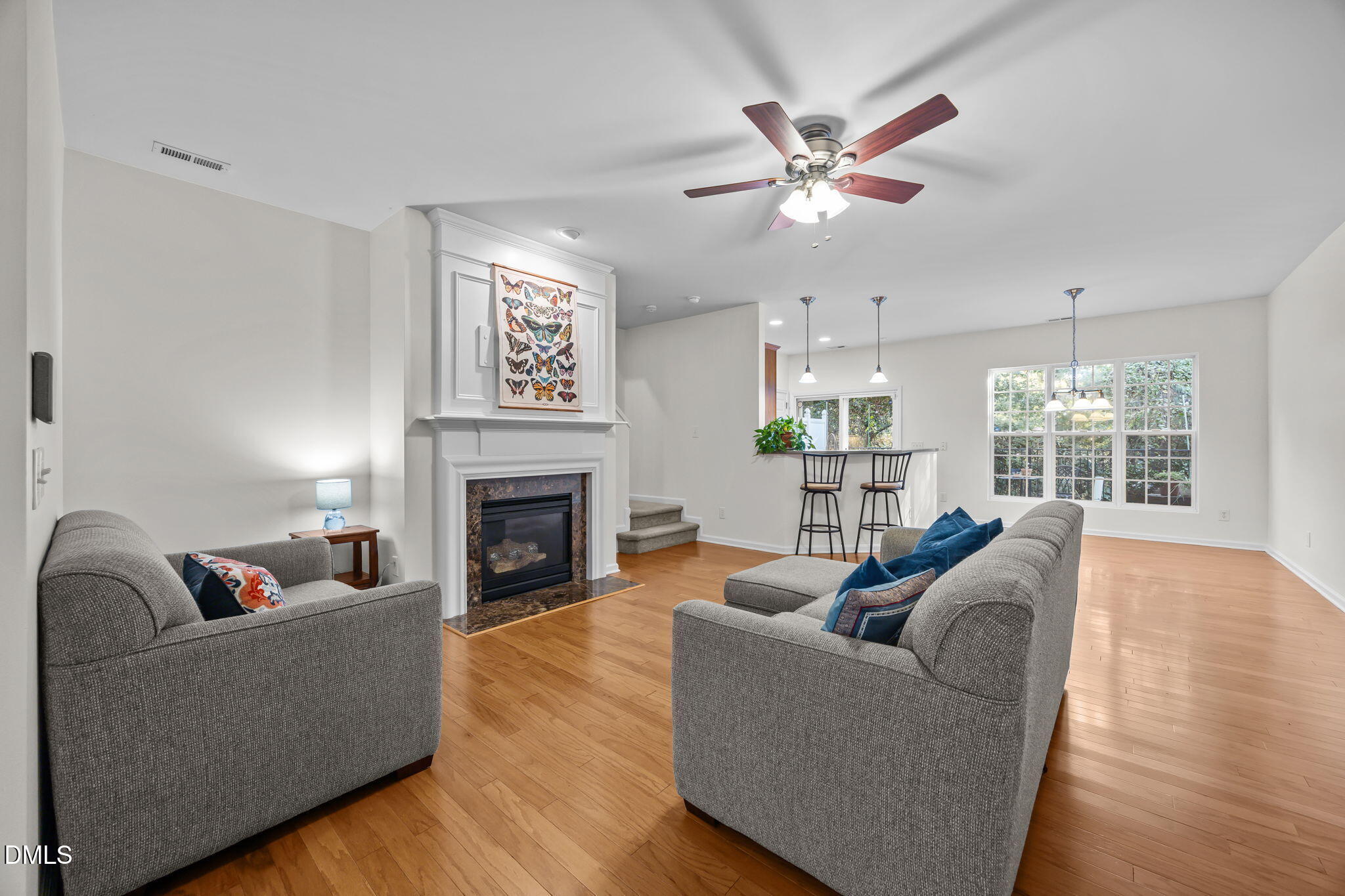 7008 Racine Way Raleigh, NC 27690 - Photo 18 of 36 a living room with furniture a fireplace and a chandelier