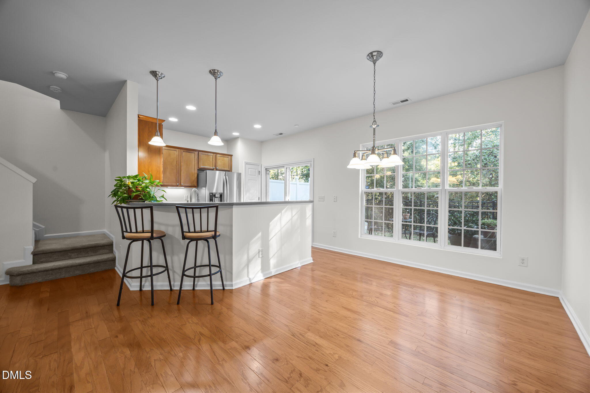 7008 Racine Way Raleigh, NC 27690 - Photo 19 of 36 a view of a dining room with furniture window and wooden floor