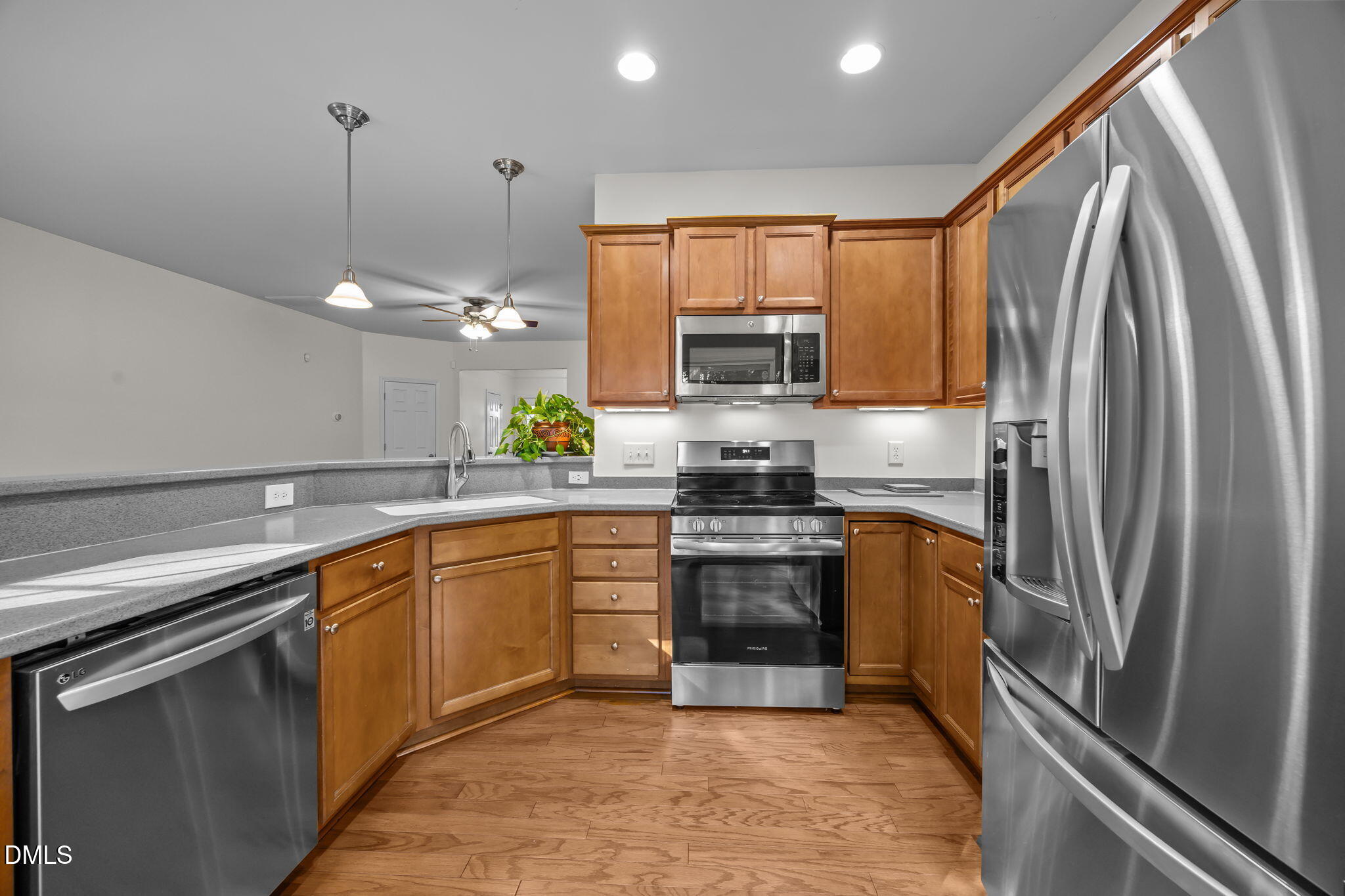 7008 Racine Way Raleigh, NC 27690 - Photo 20 of 36 a kitchen with stainless steel appliances granite countertop a refrigerator a sink a stove top oven and a dishwasher