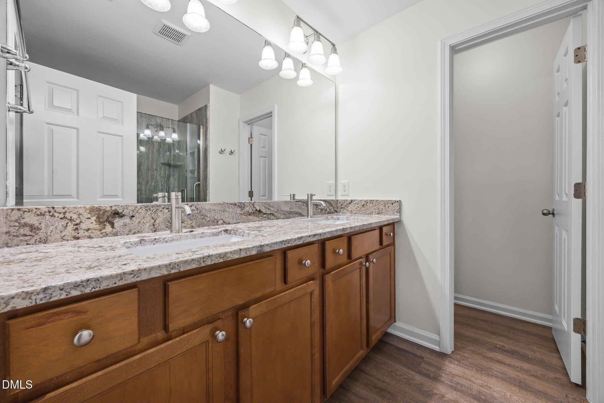 7008 Racine Way Raleigh, NC 27690 - Photo 31 of 36 a bathroom with a granite countertop sink and a mirror