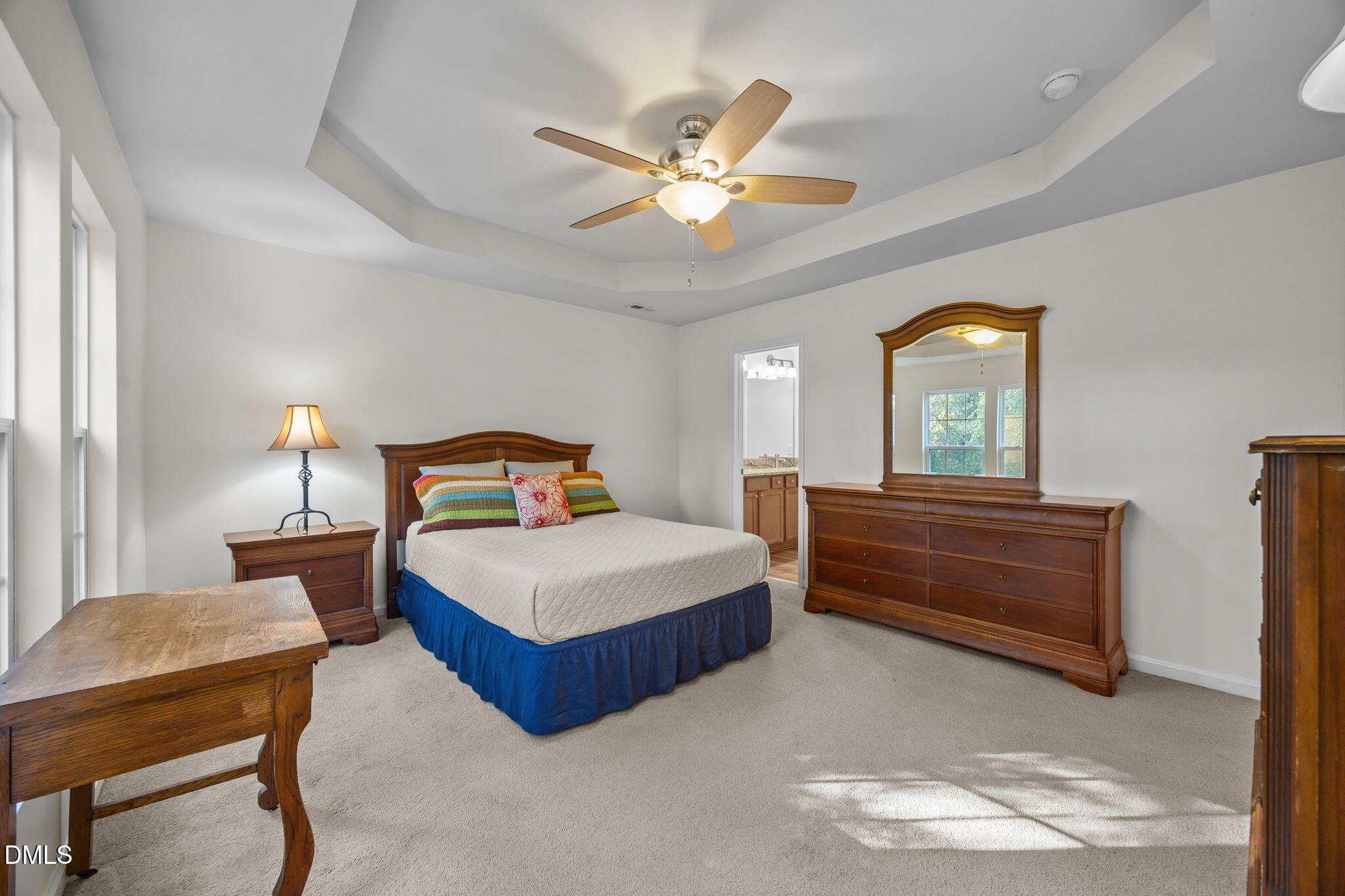 7008 Racine Way Raleigh, NC 27690 - Photo 4 of 36 a bedroom with a bed and a chandelier