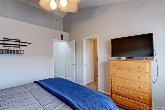 a bedroom with a bed and flat screen tv