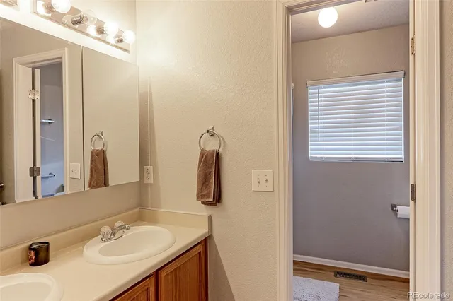 a bathroom with a sink vanity and a mirror