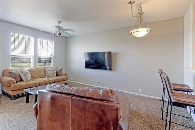 a living room with furniture a window and a chandelier