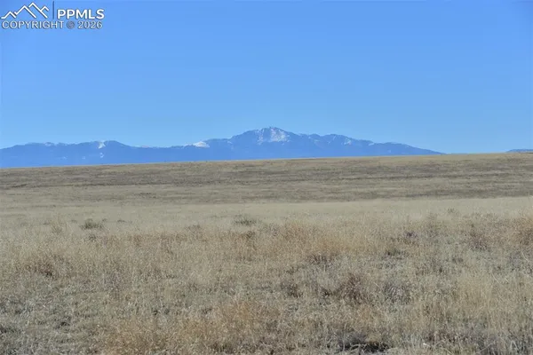 a view of an ocean beach and mountains
