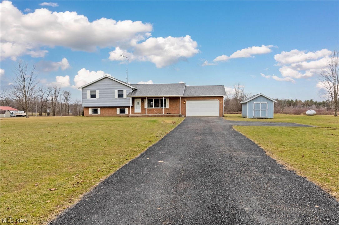 411 Adario West Road Shiloh, OH 44878 - Photo 28 of 35 Split level home with a front yard, a garage, and a storage shed