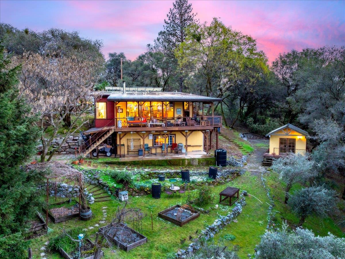 an aerial view of a house with swimming pool and garden
