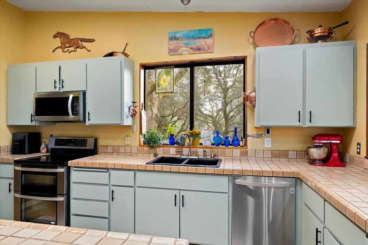 2244 Windmill Court Cool, CA 95614 - Photo 13 of 73 a kitchen with a sink cabinets and a window