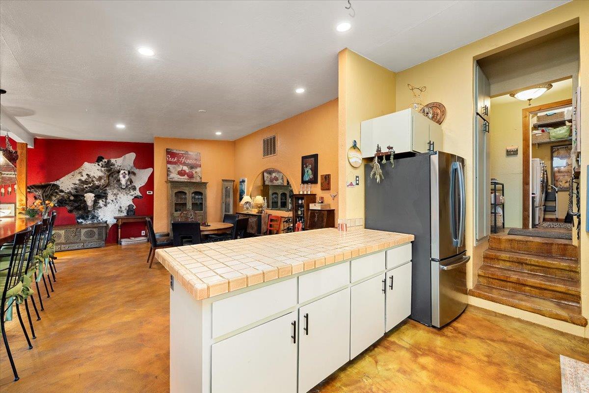 2244 Windmill Court Cool, CA 95614 - Photo 15 of 73 a kitchen with stainless steel appliances kitchen island granite countertop a refrigerator and stove