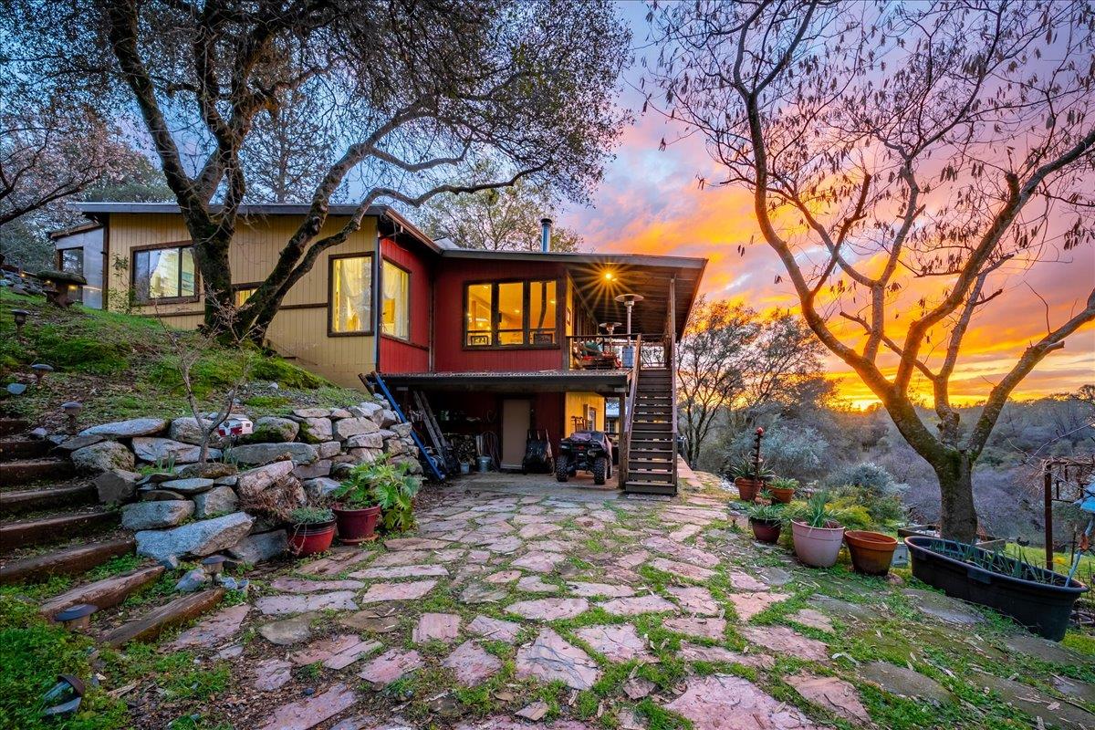 2244 Windmill Court Cool, CA 95614 - Photo 2 of 73 a front view of a house with garden and trees
