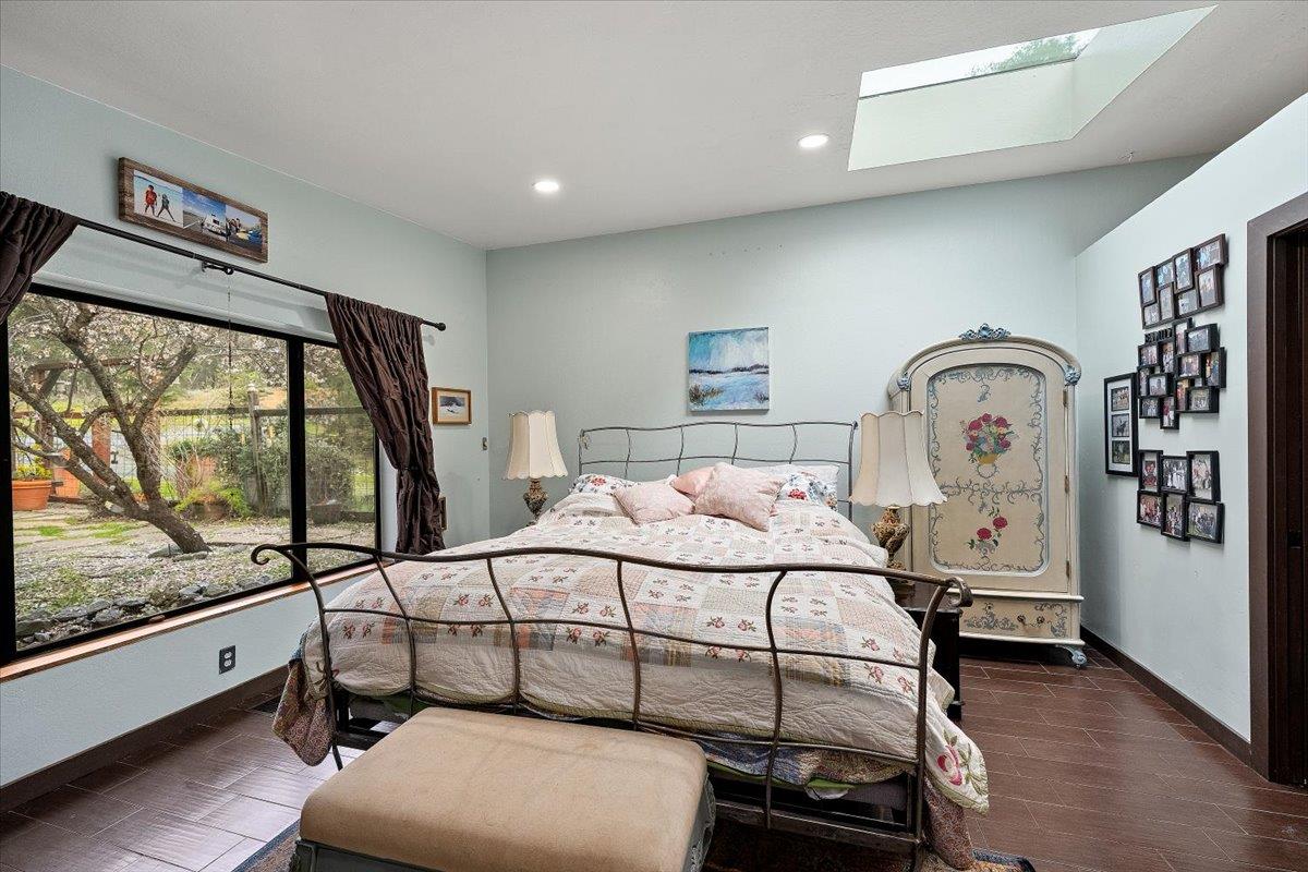 2244 Windmill Court Cool, CA 95614 - Photo 22 of 73 a bedroom with a bed a mirror on the dresser and a window