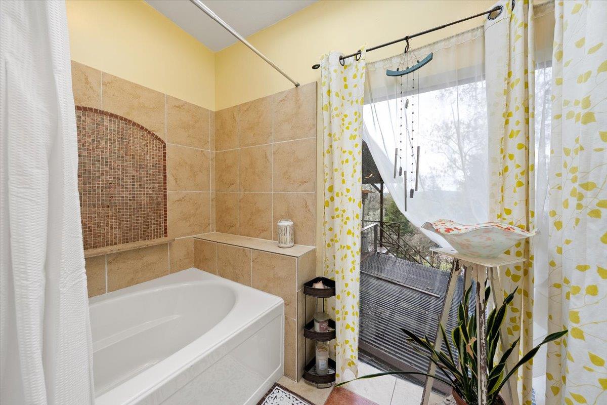 2244 Windmill Court Cool, CA 95614 - Photo 25 of 73 a bathroom with a shower and a tub