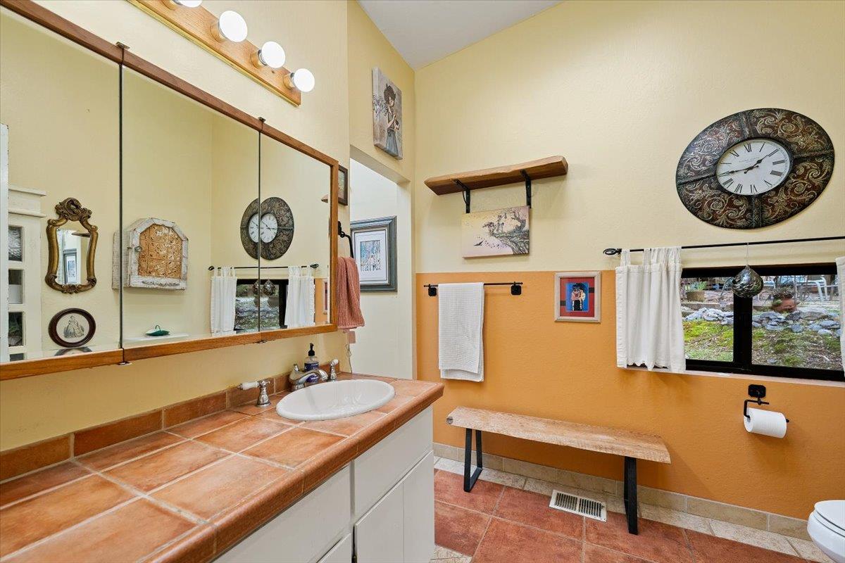 2244 Windmill Court Cool, CA 95614 - Photo 27 of 73 a bathroom with a granite countertop sink and a mirror