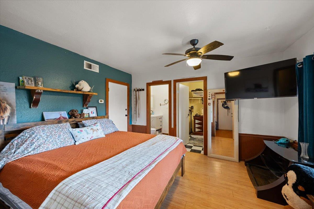 2244 Windmill Court Cool, CA 95614 - Photo 28 of 73 a bedroom with a bed and a chandelier