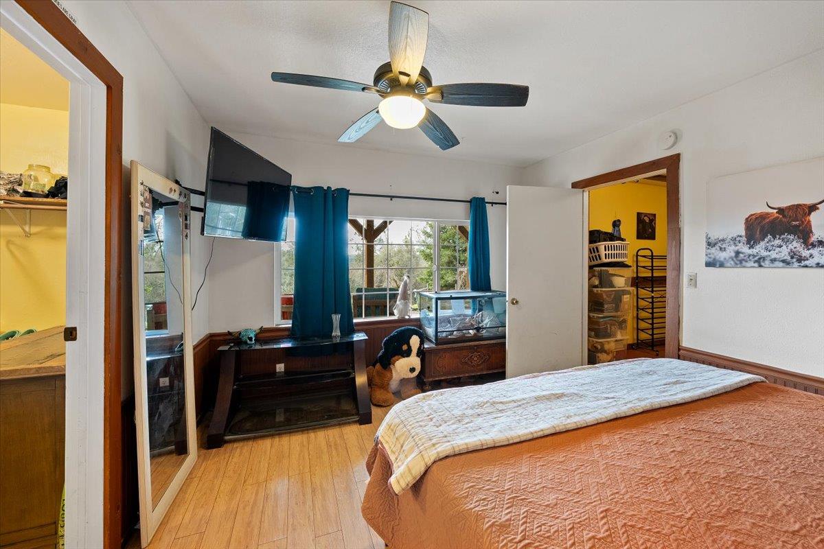 2244 Windmill Court Cool, CA 95614 - Photo 29 of 73 a bedroom with a bed and a dresser next to a window