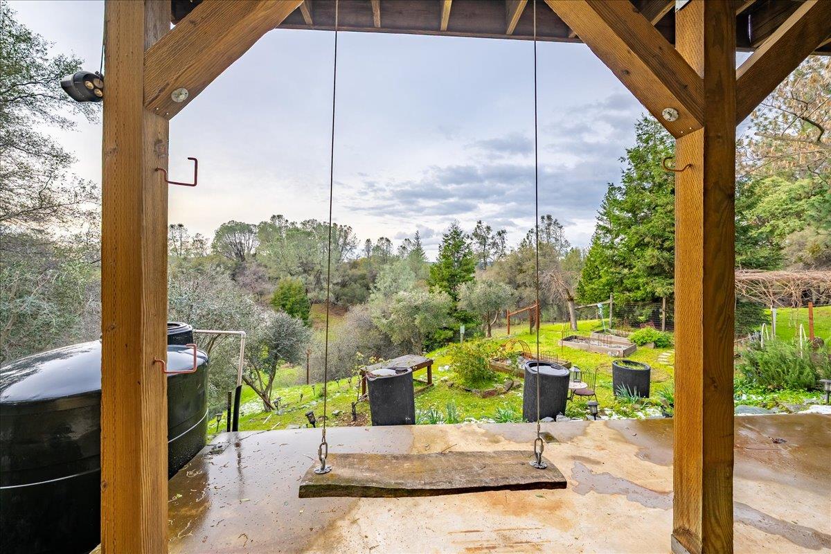 2244 Windmill Court Cool, CA 95614 - Photo 72 of 73 a view of a patio with a table chairs and a floor to ceiling window