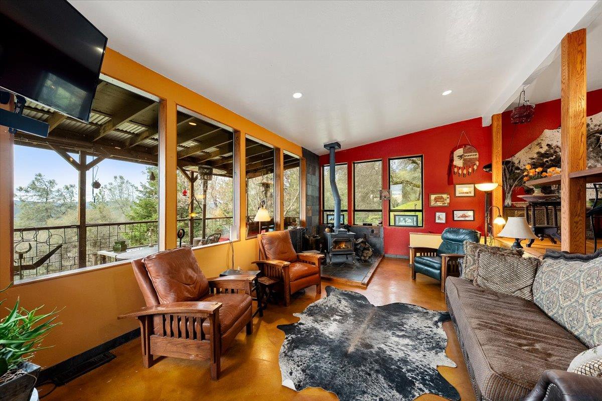 2244 Windmill Court Cool, CA 95614 - Photo 9 of 73 a living room with furniture a floor to ceiling window and a flat screen tv