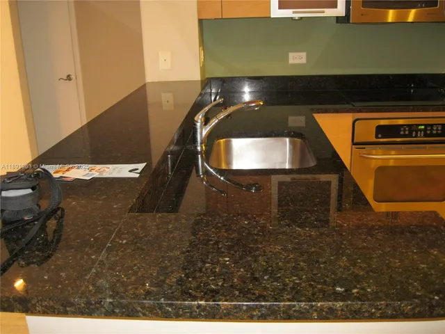 a stove top oven sitting inside of a kitchen