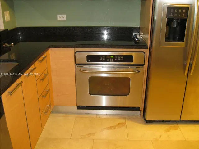 a close view of a sink a counter space and cabinets
