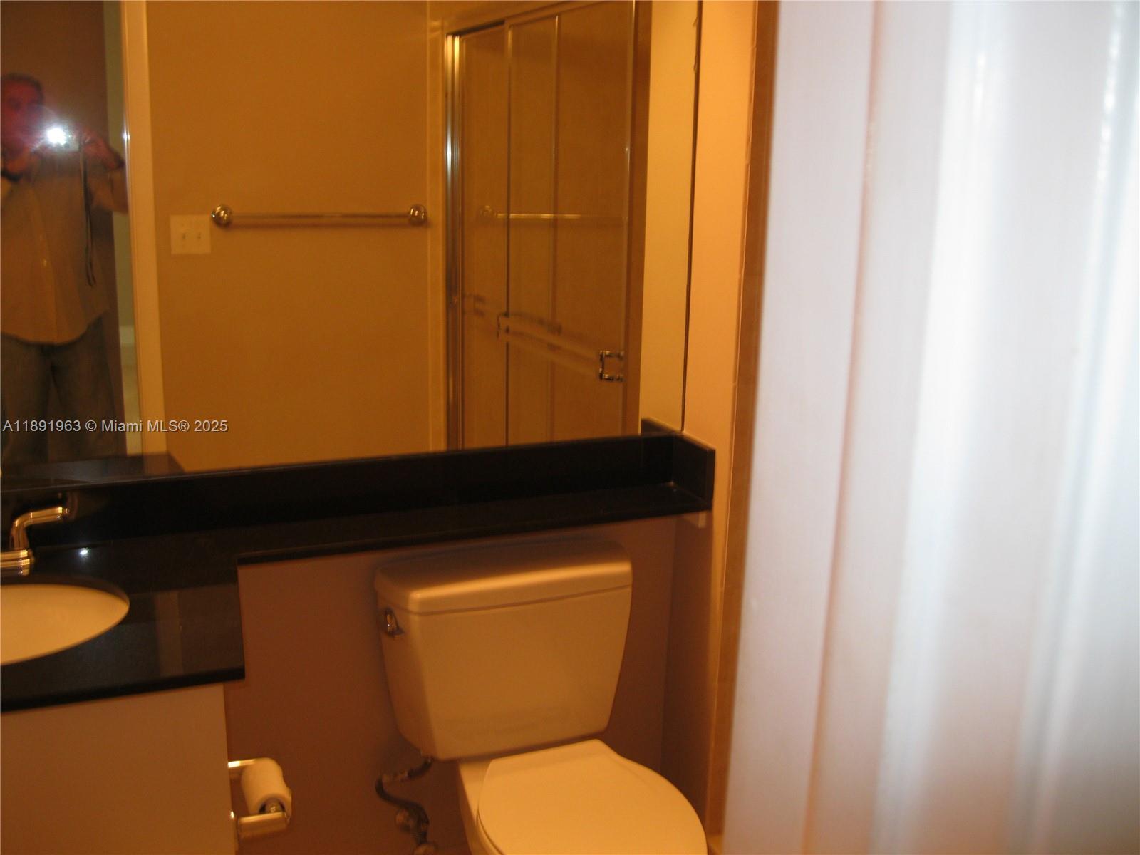 31 Southeast 5th Street, Unit 1210 Miami, FL 33131 - Photo 20 of 26 a bathroom with a toilet