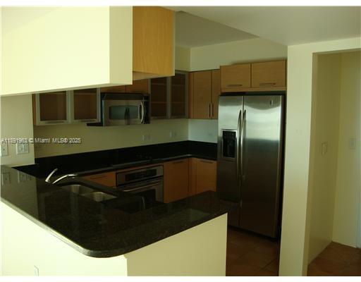 31 Southeast 5th Street, Unit 1210 Miami, FL 33131 - Photo 6 of 26 a kitchen with a refrigerator and a sink