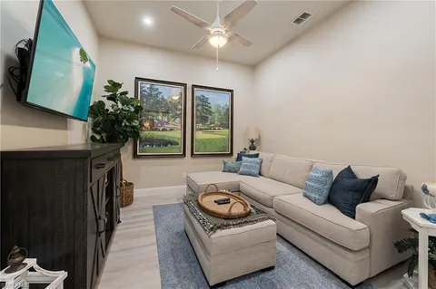 a spacious bedroom with a bed a dresser and potted plant