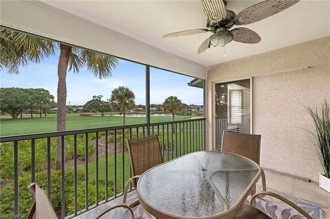 a balcony with table and chairs