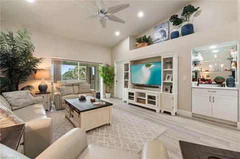 a living room with furniture and a lamp
