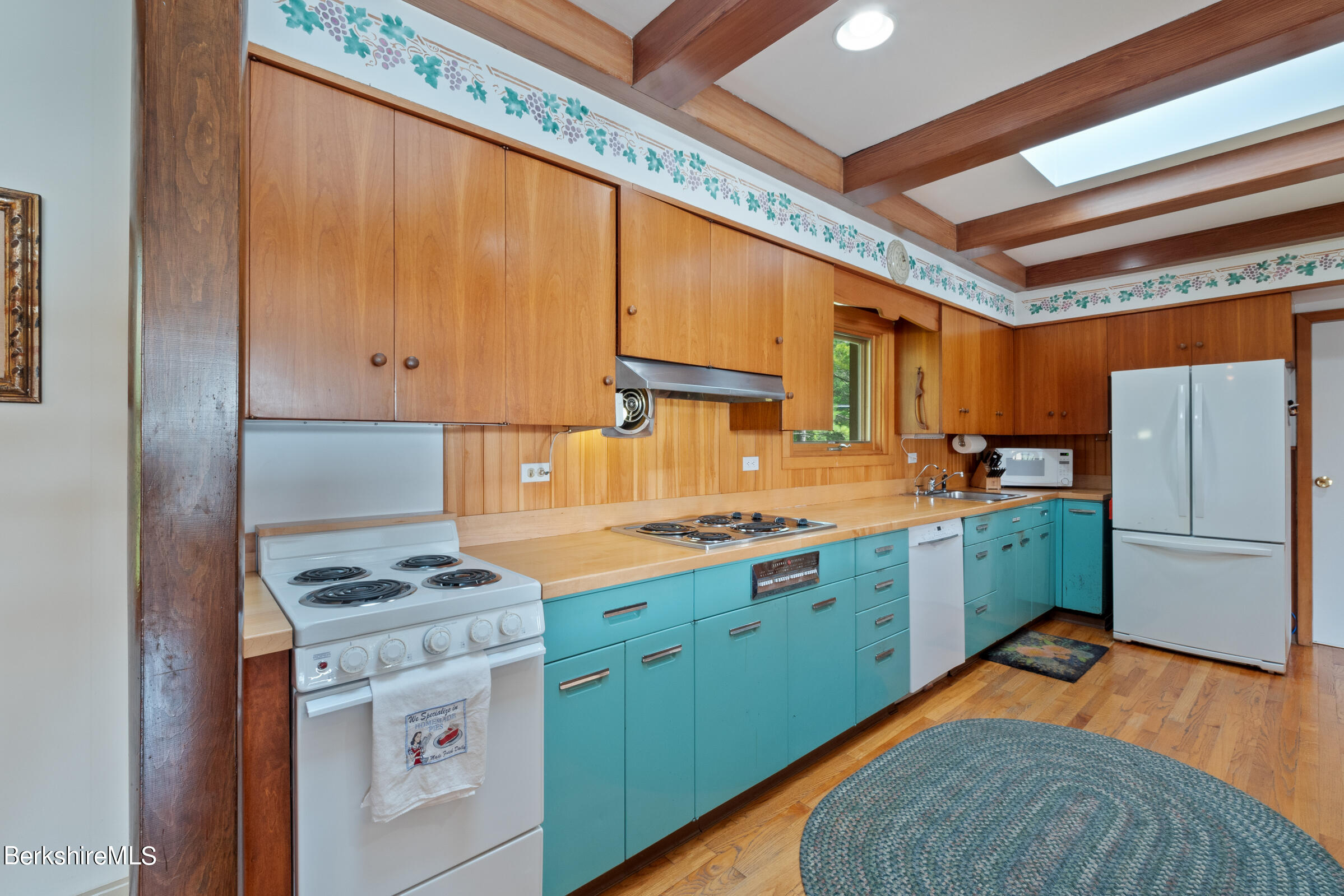 61 Bramble Lane Lenox, MA 01240 - Photo 18 of 42 a kitchen with a refrigerator a stove top oven a sink and dishwasher