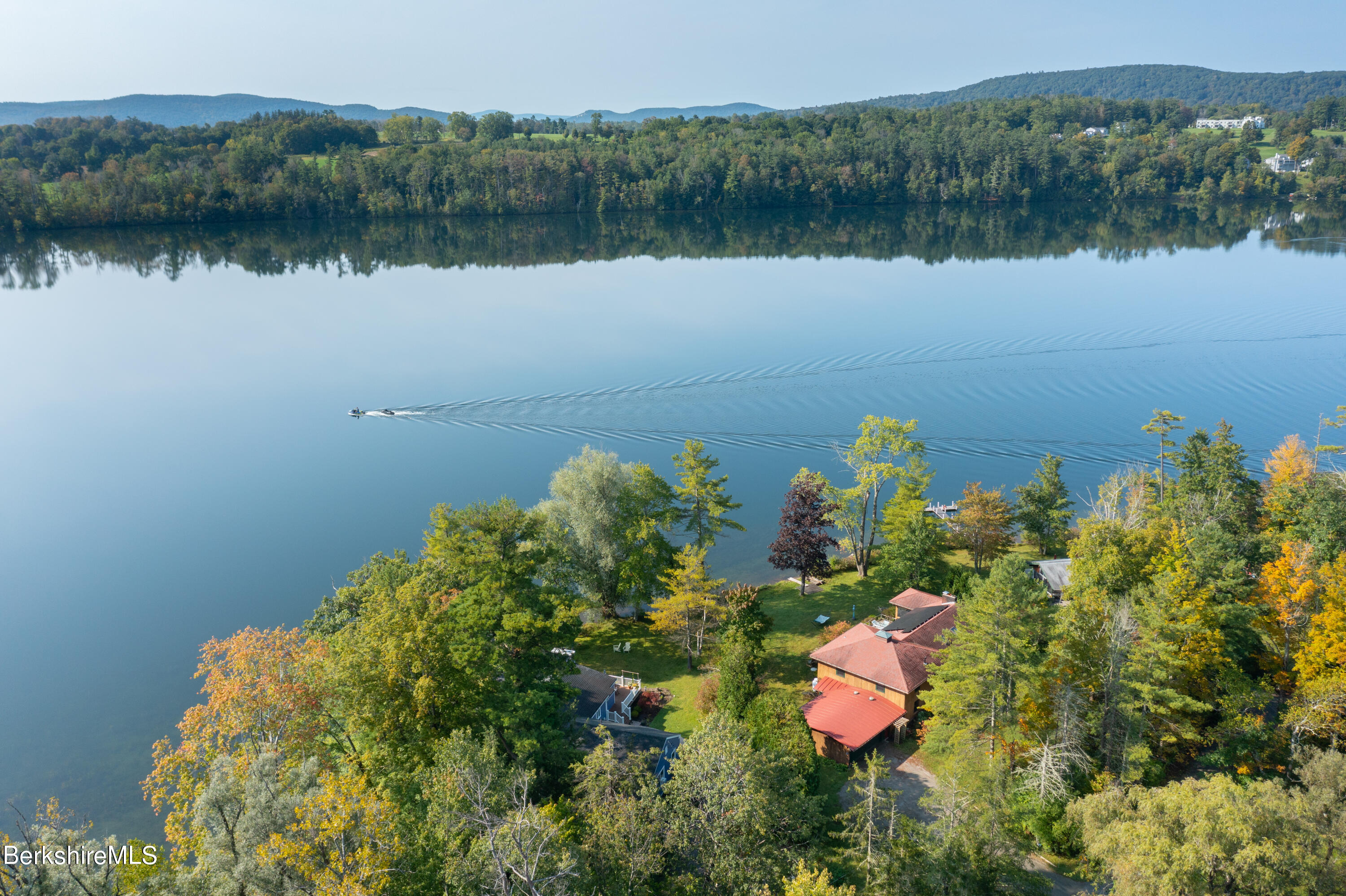 61 Bramble Lane Lenox, MA 01240 - Photo 3 of 42 a view of a lake with a house