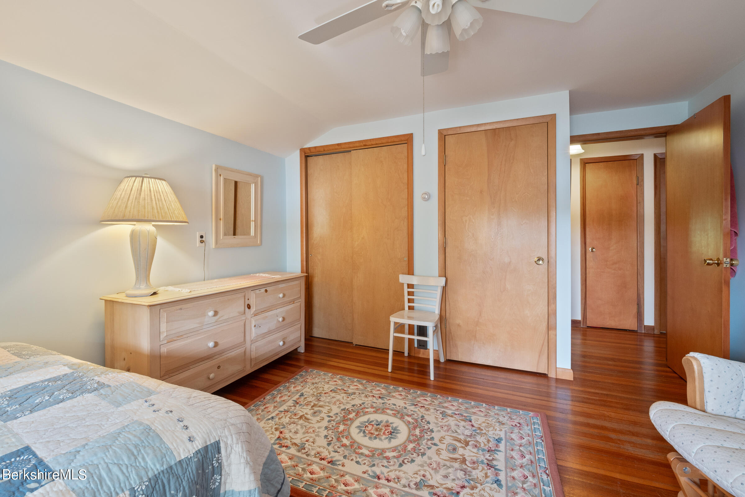 61 Bramble Lane Lenox, MA 01240 - Photo 38 of 42 a spacious bedroom with a bed and a table in it