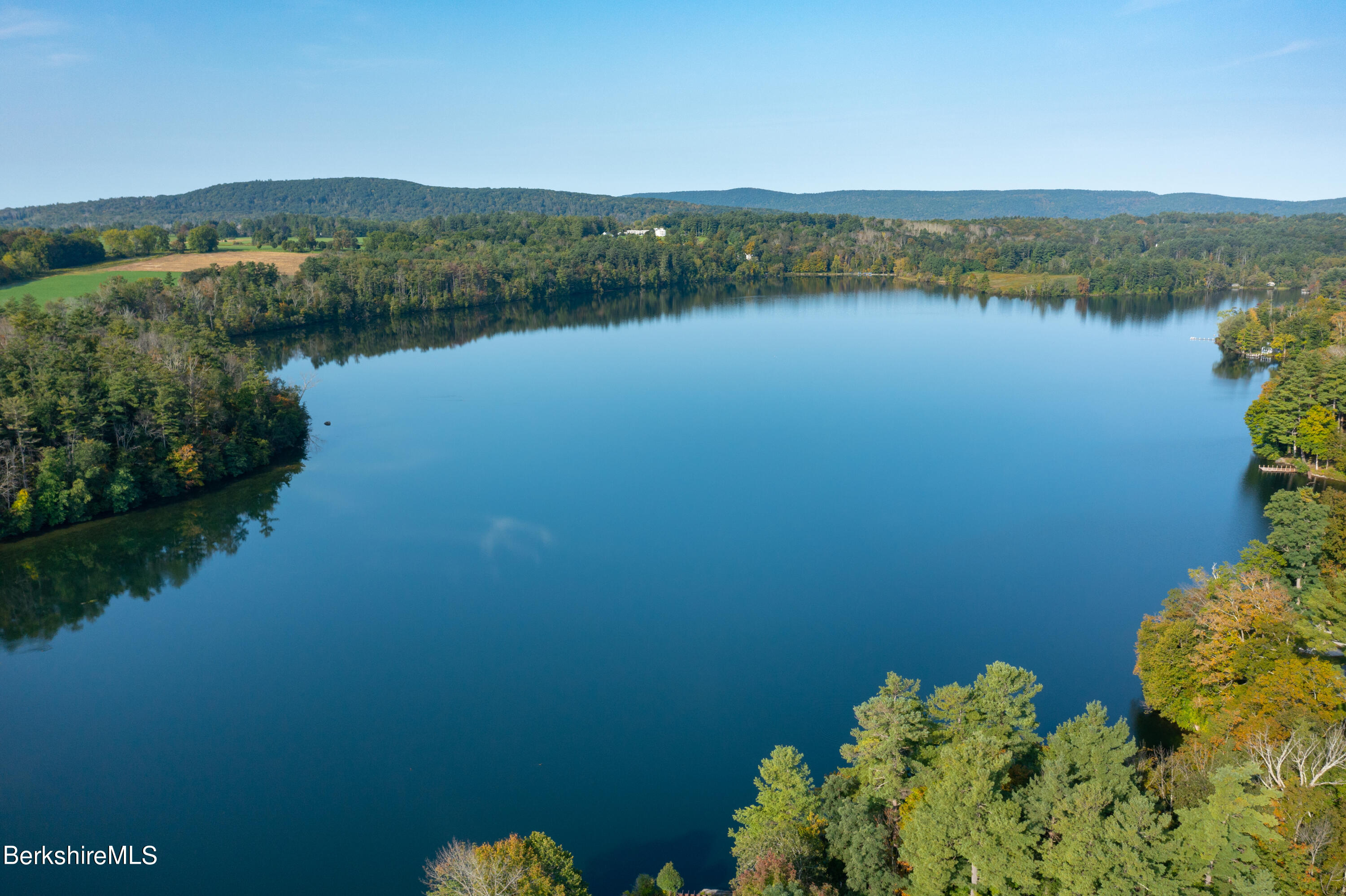 61 Bramble Lane Lenox, MA 01240 - Photo 5 of 42 a view of a lake with a mountain in the background
