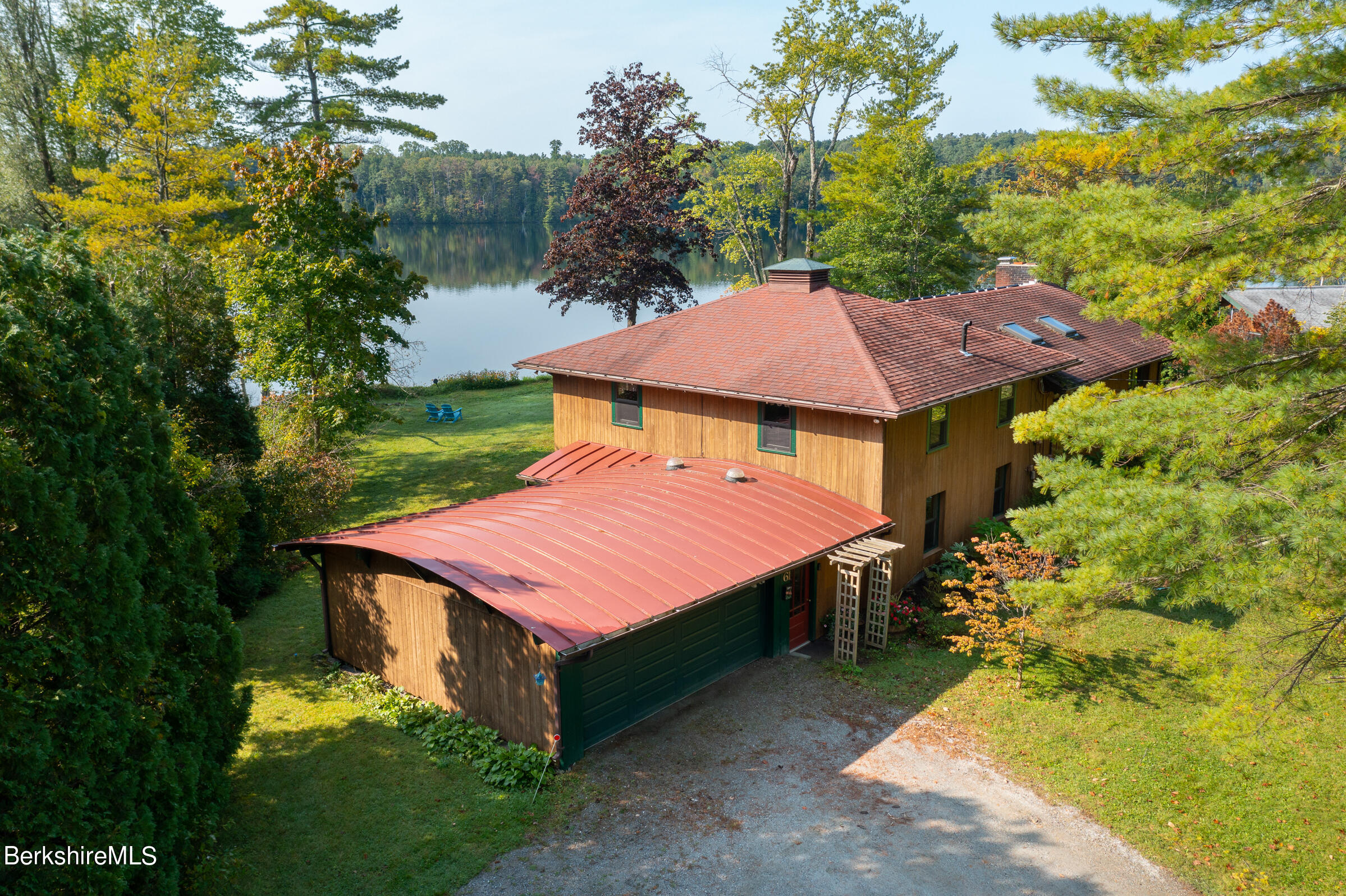 61 Bramble Lane Lenox, MA 01240 - Photo 7 of 42 a aerial view of a house with table and chairs under an umbrella