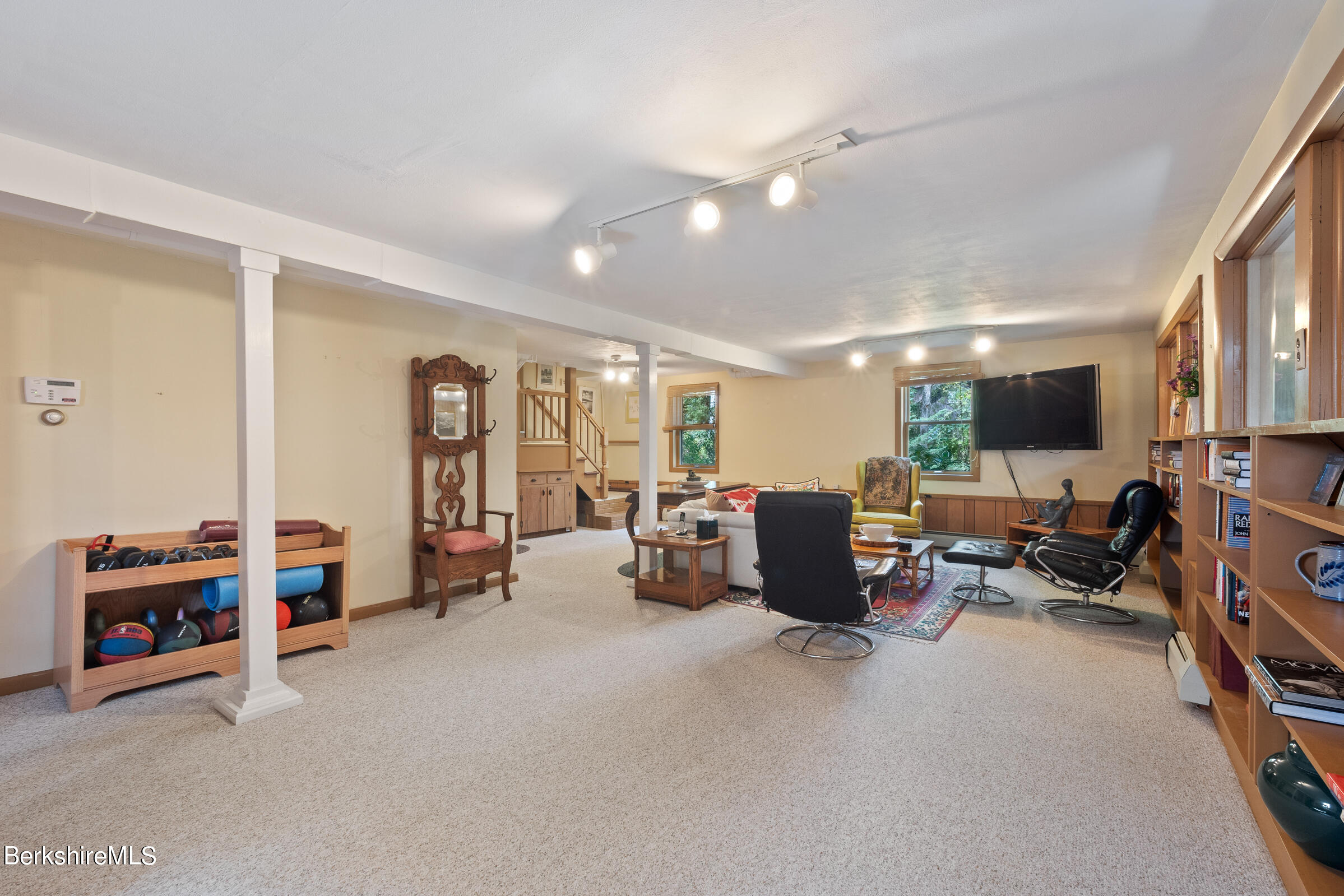 61 Bramble Lane Lenox, MA 01240 - Photo 10 of 42 a living room with furniture and a flat screen tv