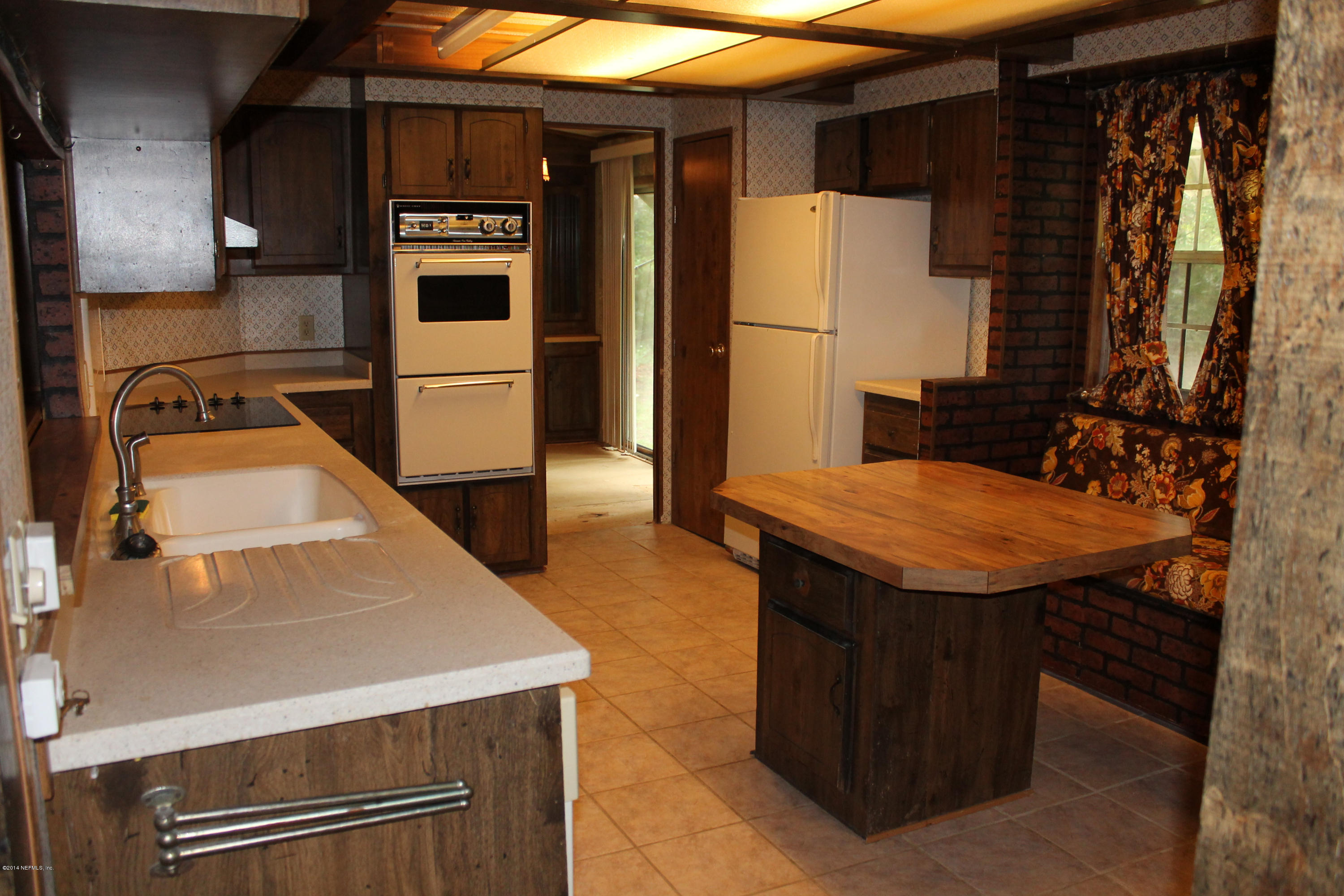 5700 Datil Pepper Road St. Augustine, FL 32086 - Photo 11 of 17 a kitchen with stainless steel appliances granite countertop a sink and a refrigerator