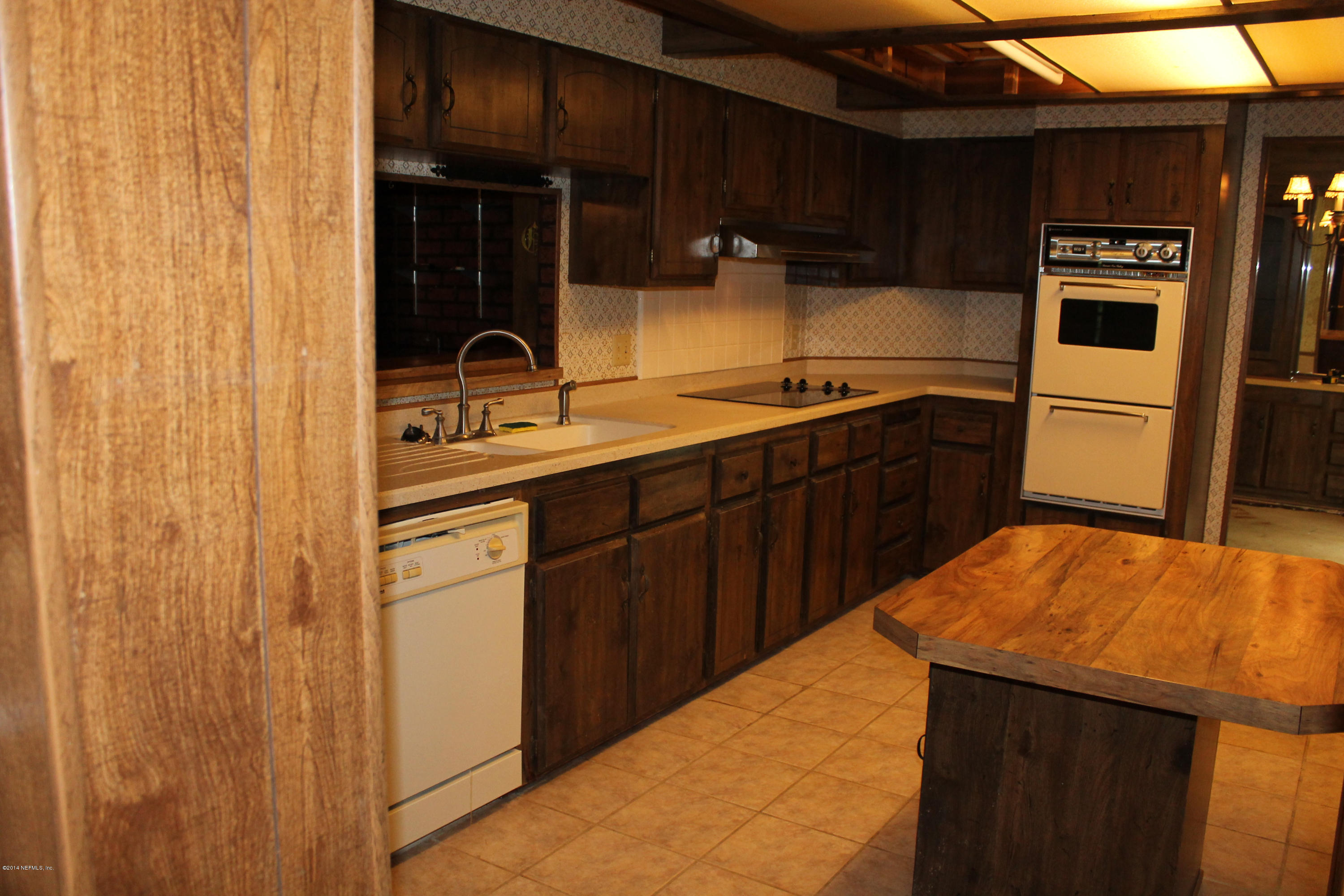 5700 Datil Pepper Road St. Augustine, FL 32086 - Photo 12 of 17 a kitchen with stainless steel appliances a sink cabinets and wooden floor