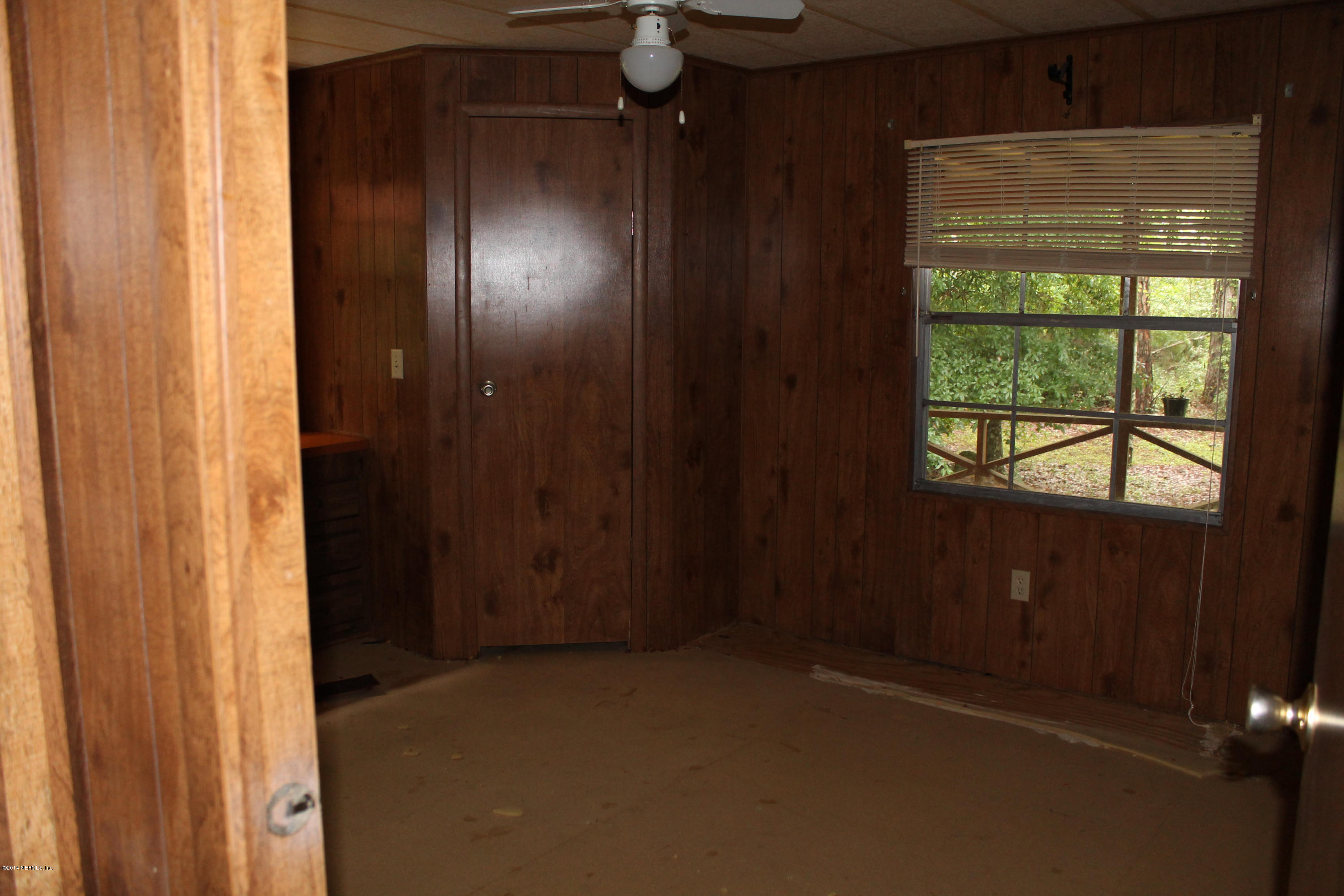 5700 Datil Pepper Road St. Augustine, FL 32086 - Photo 15 of 17 an empty room with windows and wooden door
