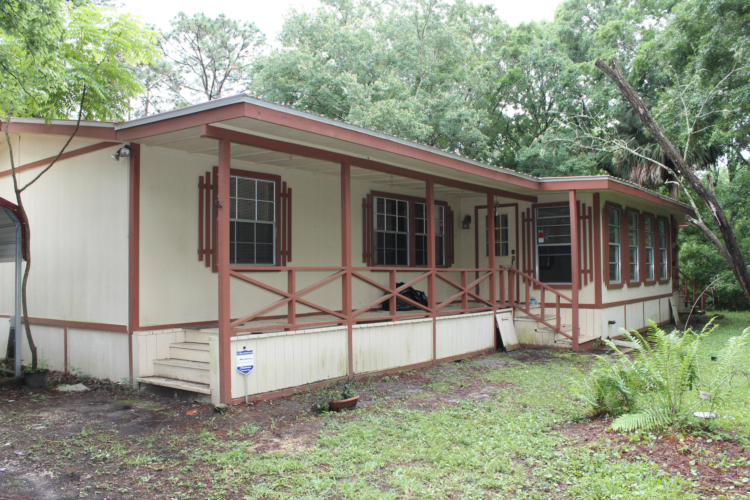 5700 Datil Pepper Road St. Augustine, FL 32086 - Photo 3 of 17 a view of a house with a yard and wooden fence